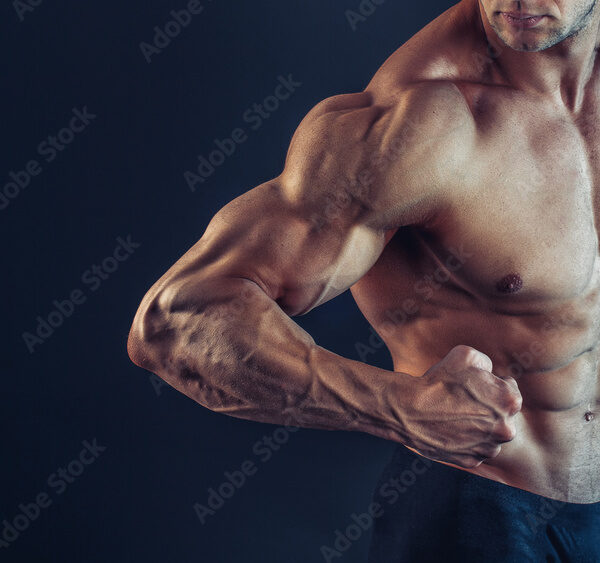 Unrecognizable Strong Athletic Sexy Muscular Man Poising , Showing biceps and delts on Black Background.